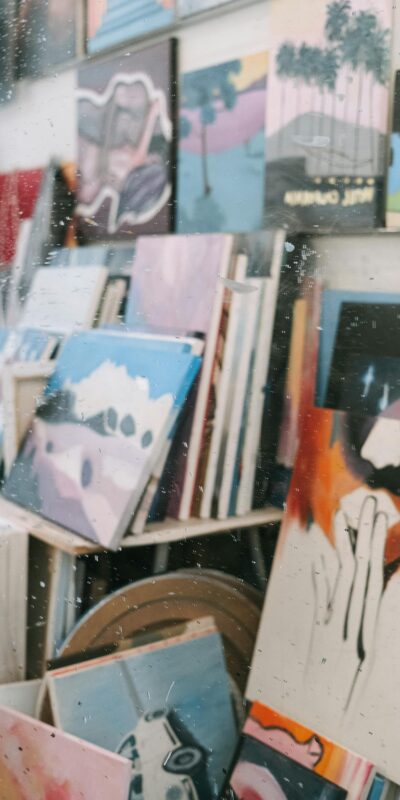 Photo by Ivan Samkov Explore diverse and colorful art pieces displayed in a vibrant art exhibition setting.